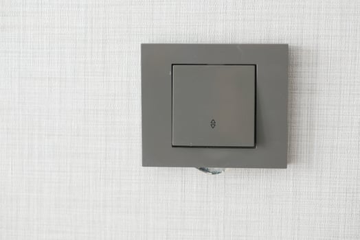 a lighting switch against white wall photo
