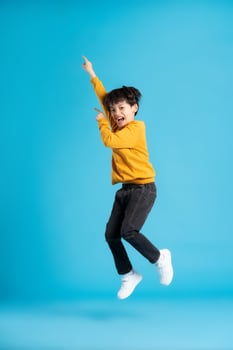 full body image of asian boy posing on blue background photo