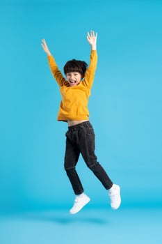 full body image of asian boy posing on blue background photo