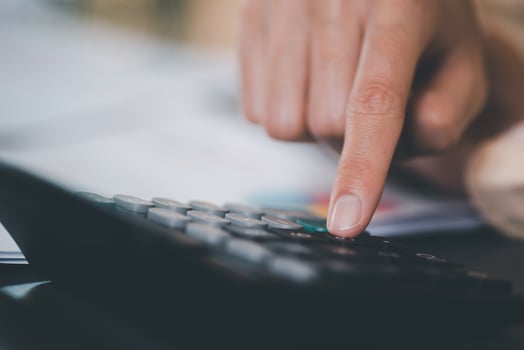 Businessman use calculator to calculate documents, profit and loss statement review concept of company performance, effective tax deduction planning for individuals and companies paying tax rates. photo