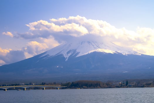 Mount Fuji, large clouds covering the top of the mountain.Landscape View With Water At Kawaguchiko Lake, Japan photo