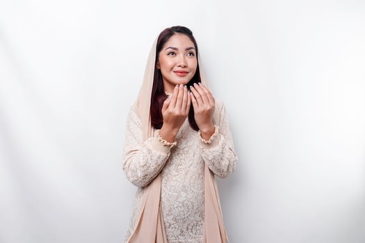 Religious beautiful Asian Muslim girl wearing a headscarf praying to God. photo