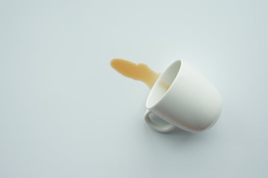 cup of coffee spilled on white photo