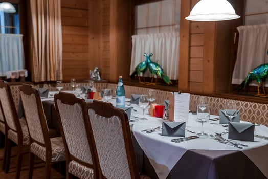 Illuminated pendant light over table in hotel photo