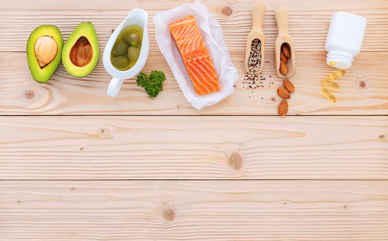 Ketogenic low carbs diet concept. Ingredients for the healthy foods selection setup on wooden background with copy space. photo