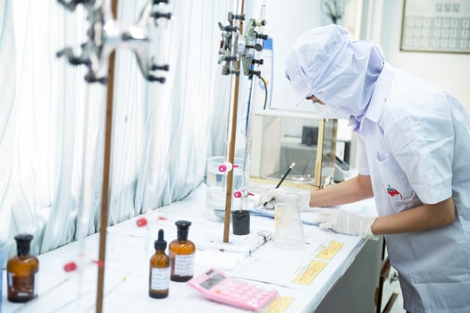 Asian female specialist in quality control lab examining tomato ingredient food in research lab, food industry photo