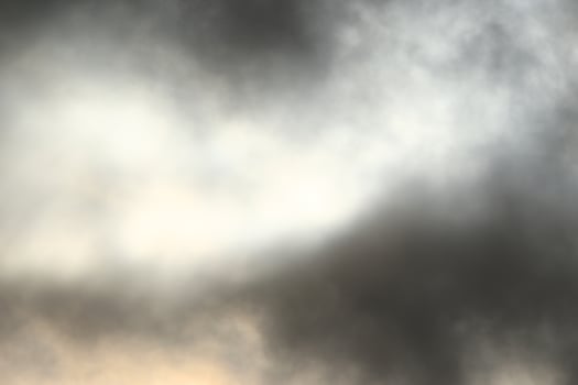 Sun behind the darl clouds photo