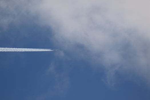 A plane and vapor trails in the sky photo