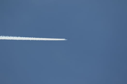 A plane and vapor trails in the sky photo