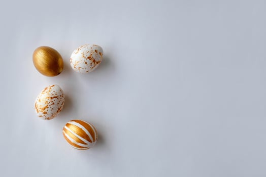 Top view Easter eggs painted with gold paint in various patterns . White background. photo