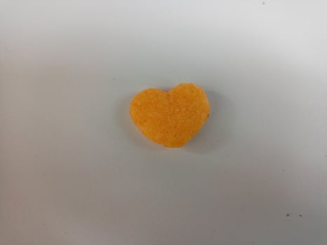 close up of love shaped snack on white background,with copy space area. photo