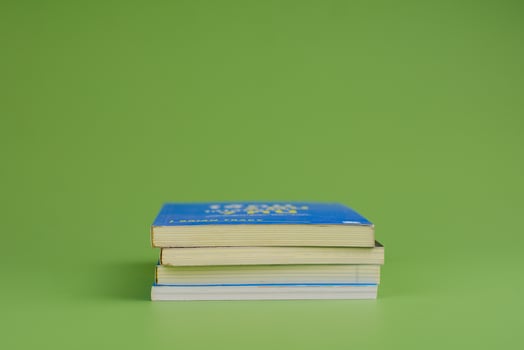 Books. Stack of books stacked on light green background. Reading. Reading concept. and collection of books photo