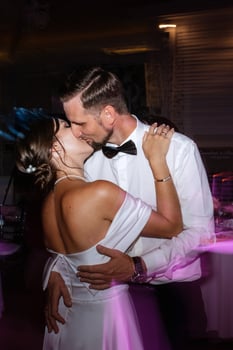 the first dance of the bride and groom inside a restaurant photo