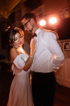 the first dance of the bride and groom inside a restaurant photo