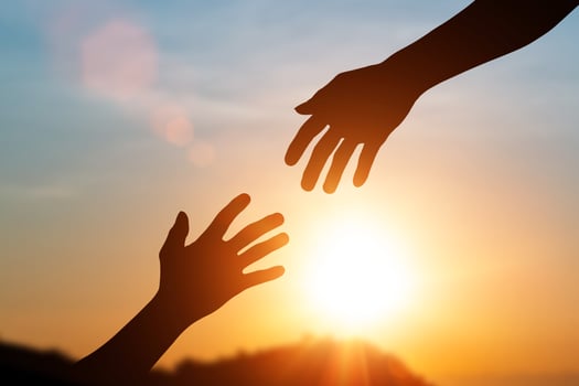 Silhouette of helping hand and develop a friendship. international day of peace concept. helping hand to a friend photo