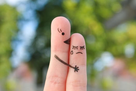 Finger art of people. Child cries, mother reassures his. photo