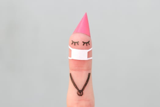 Finger art of women celebrates birthday in medical mask from COVID-2019. Concept of lonely person. photo