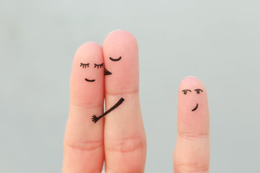 Fingers art of happy family. Concept of couple kisses, child glances after them. photo