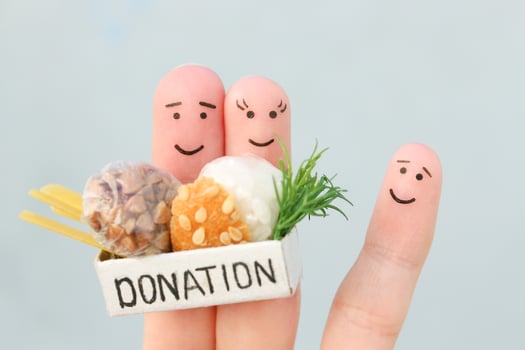Fingers art of family. Man  and woman holding donation box with food. photo