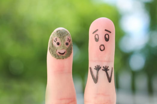 Fingers art of couple. Husband saw his wife with clay face mask and was afraid. photo
