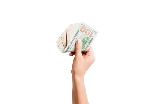 Female hand giving money on white isolated background. Top view of dollar banknotes. Bribe concept. Debt and loan concept photo