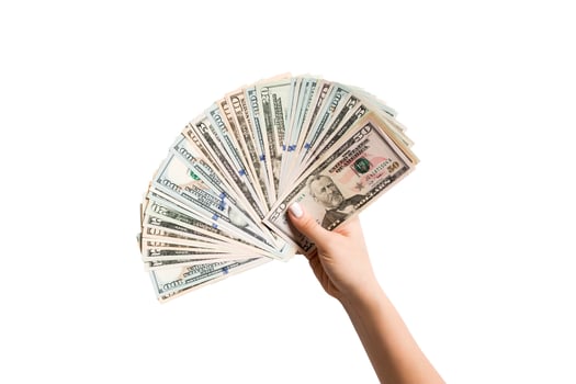 Top view of female hand giving a fan of dollar bills on isolated background. Profit and luxury concept photo