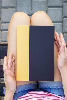 A young woman holding a book in the park. photo