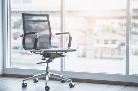 Black working chair in white office room with sunlight. photo