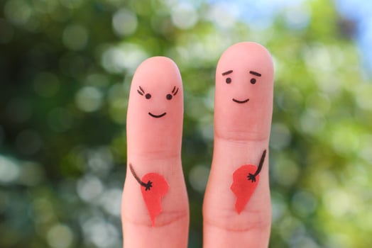 Fingers art of happy couple. Woman and man holding broken heart. Concept of joy after divorce. photo