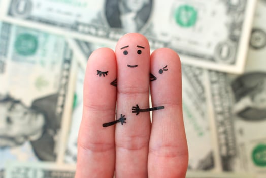 Fingers art. Concept of girls kisses boy on cheek on background of money. photo