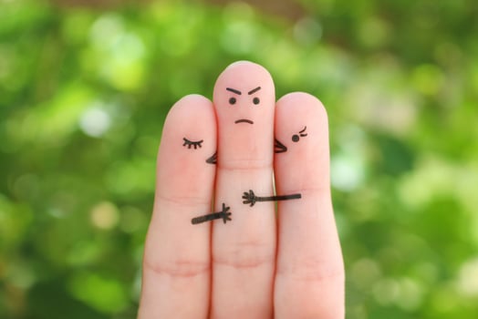Fingers art. Concept of girls kisses boy on cheek. Man sad because he did not know whom to choose. photo
