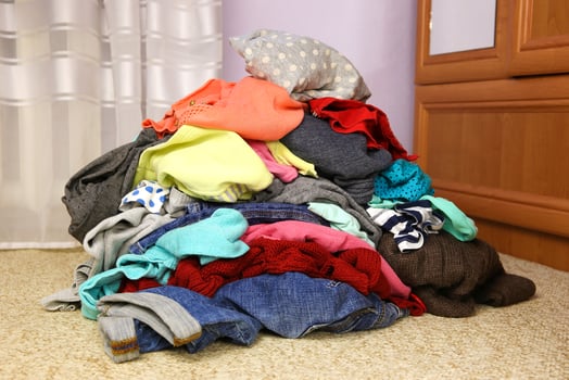 Pile of carelessly scattered clothes on floor. photo