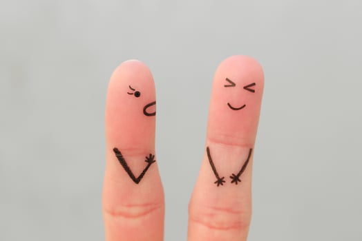 Fingers art of family during quarrel. Concept of wife shouts on husband, man laughs. photo