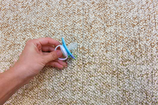 Baby pacifier fell on the dirty floor. photo