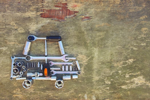 Tool to repair in form of car on wooden background. Top view. Flat lay. Toned image. photo