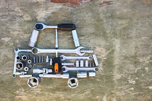 Tool to repair in form of car on wooden background. Top view. Flat lay. photo