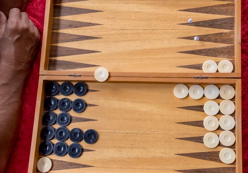 man throws dice while playing tabla. photo