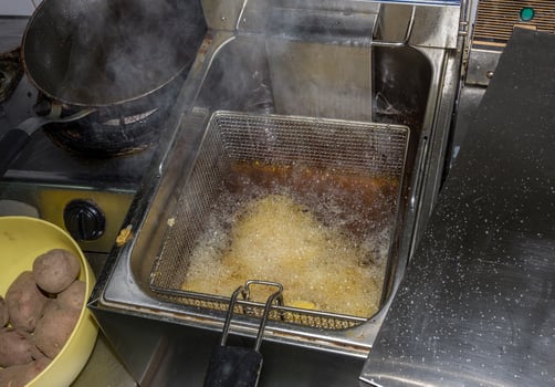 fryer for potatoes with fries with boiling oil. Concept fast food restaurant,  kitchen equipment photo