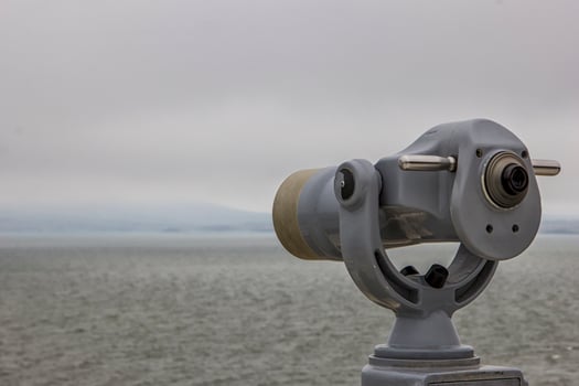 Coin Operated telescope viewer next to the waterside promenade looking out to the bay and city. photo