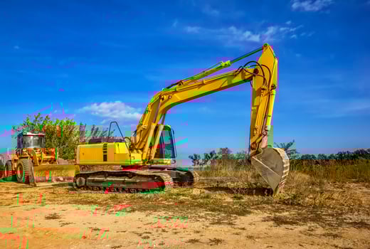 Day view of yellow bulldozer and excavator with a shovel after work. photo