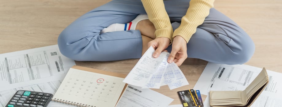 Financial owe asian woman, female sitting on floor home, stressed and confused by calculate expense from invoice or bill, have no money to pay, mortgage or loan. Debt, bankruptcy or bankrupt concept. photo