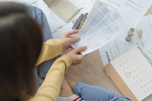 Financial owe asian woman, female sitting on floor home, stressed and confused by calculate expense from invoice or bill, have no money to pay, mortgage or loan. Debt, bankruptcy or bankrupt concept. photo