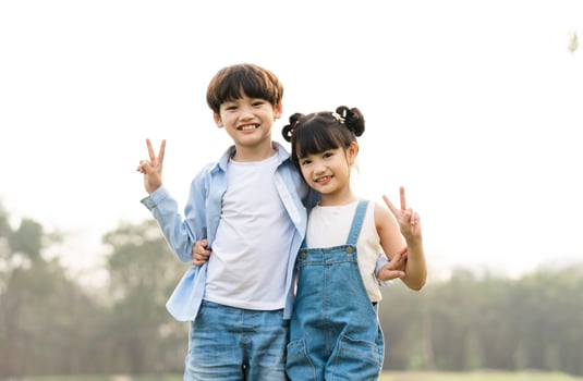 image of brother and sister having fun in the park photo