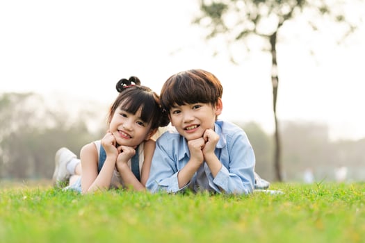 image of brother and sister having fun in the park photo