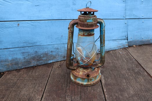 antique petromak lamp or teplok which still uses kerosene fuel on wood background photo