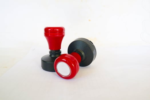 Stamp, modern Stamp, Red Handle Rubber Stamp Top View Isolated on White Background. photo