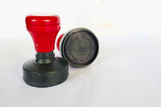 Stamp, modern Stamp, Red Handle Rubber Stamp Top View Isolated on White Background. photo