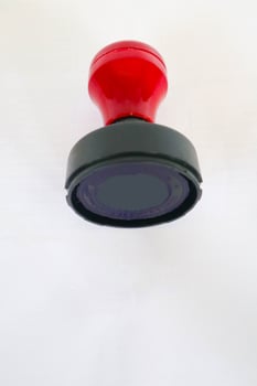Stamp, modern Stamp, Red Handle Rubber Stamp Top View Isolated on White Background. photo