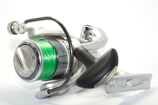 Fishing reels is a leisure sport or hobby of the unemployed, fishing is a popular thing for people to fish to eat and is a sport on a white background. photo