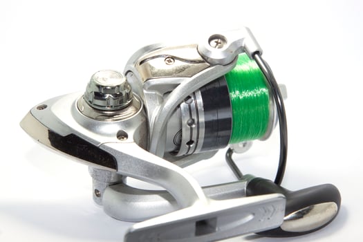 Fishing reels is a leisure sport or hobby of the unemployed, fishing is a popular thing for people to fish to eat and is a sport on a white background. photo